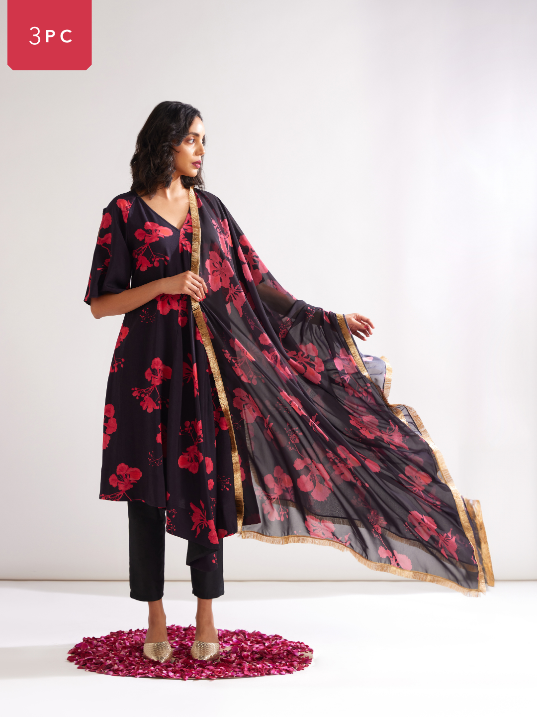 Asymmetrical Gulmohar kurta with cut out sleeves paired with pegged pants along with dupatta- Rich black