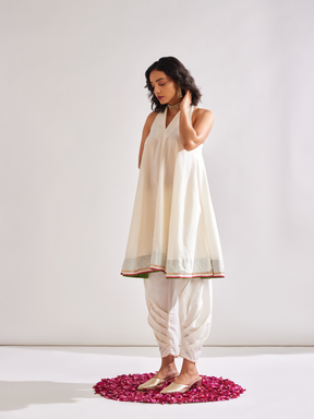 Back overlap halter neck kurta paired with side pleated pants along with dupatta- Ivory