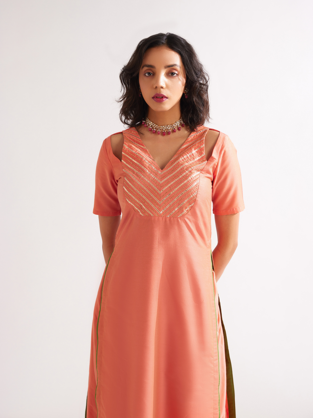 Shoulder cut-out kurta highlighted with gota patti yoke paired with side pleated pants along with dupatta- Peach