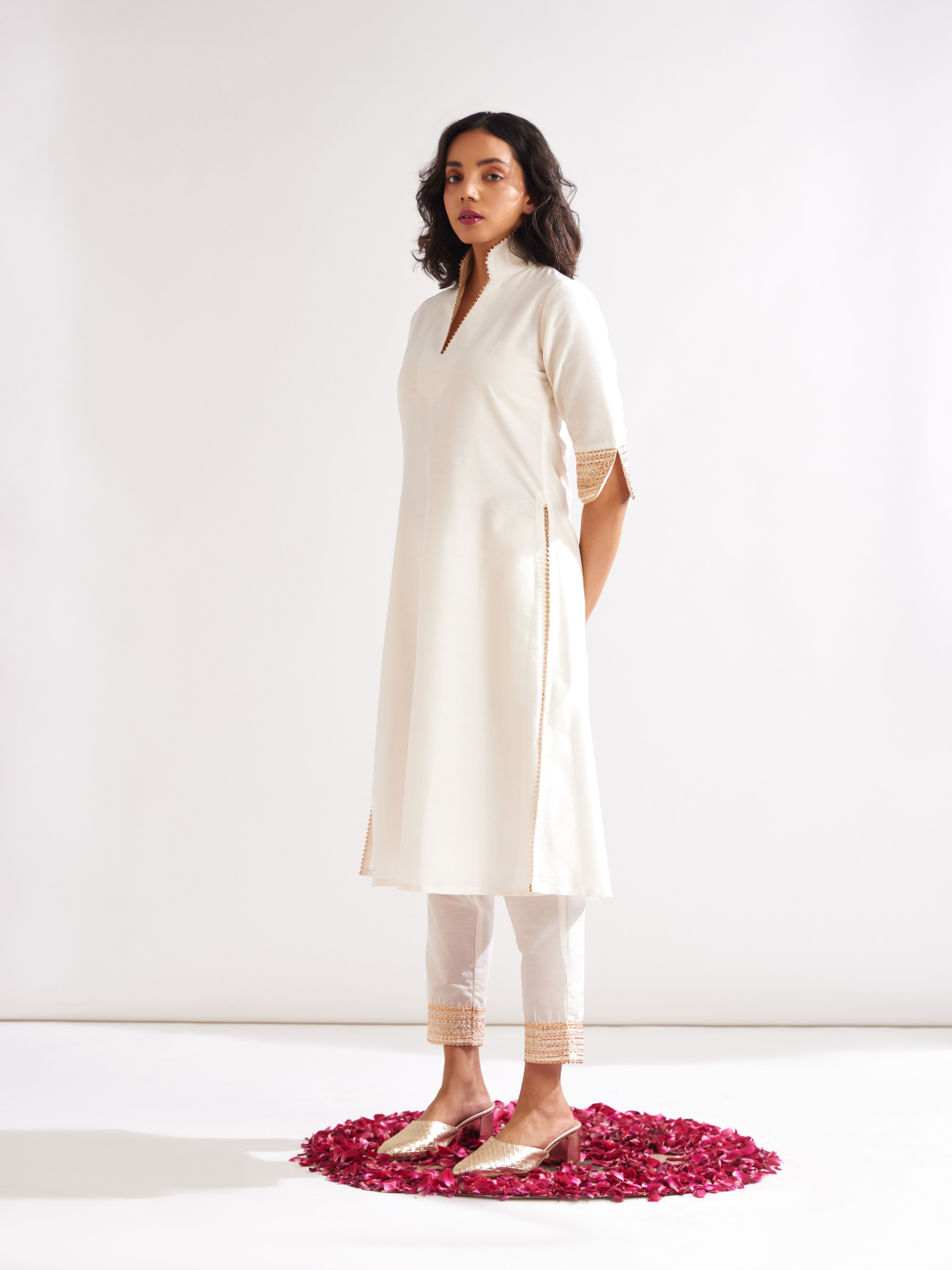 Stand collar straight kurta highlighted with gota patti with pegged pants along with dupatta- Ivory