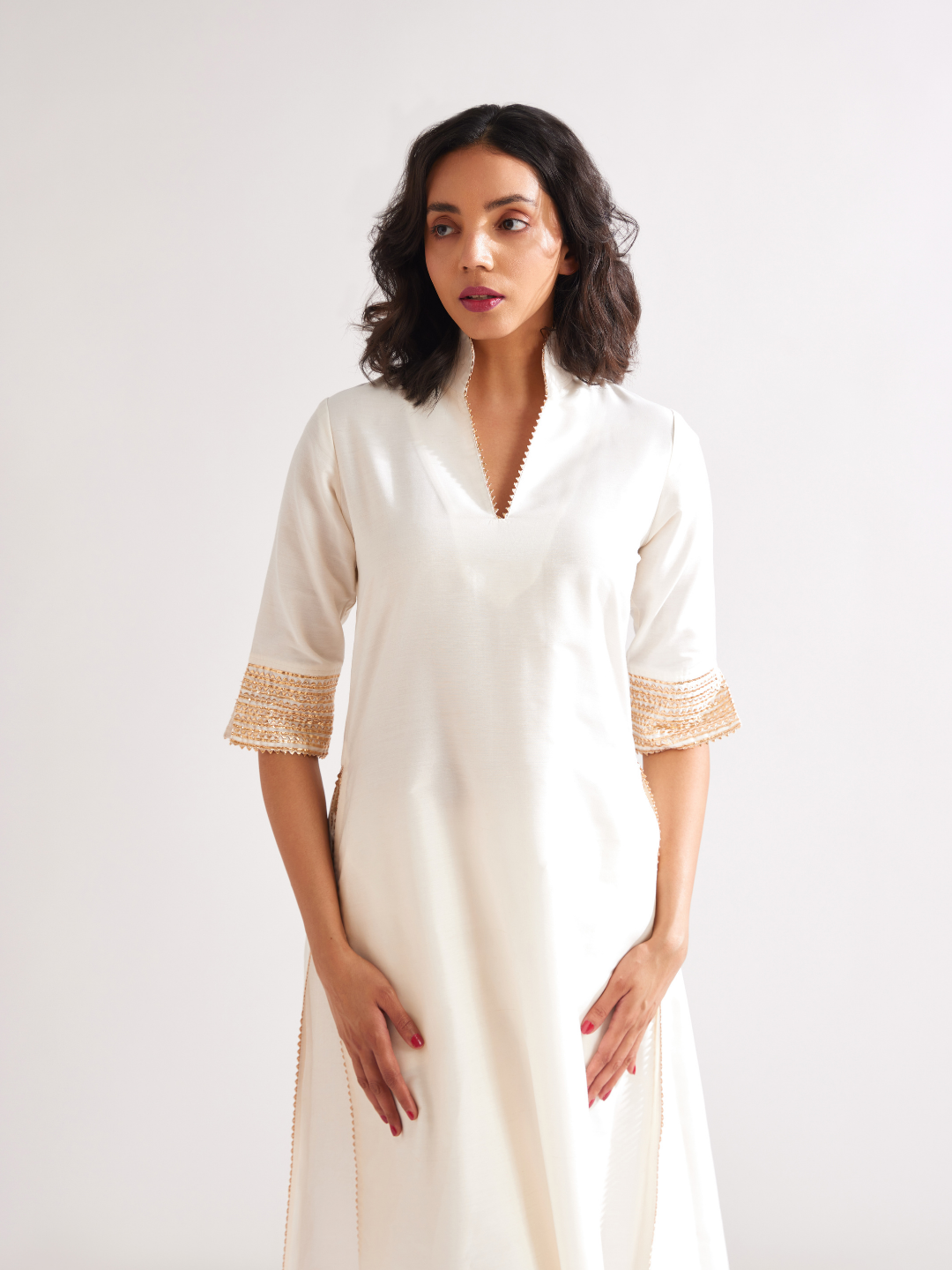 Stand collar straight kurta highlighted with gota patti with pegged pants along with dupatta- Ivory