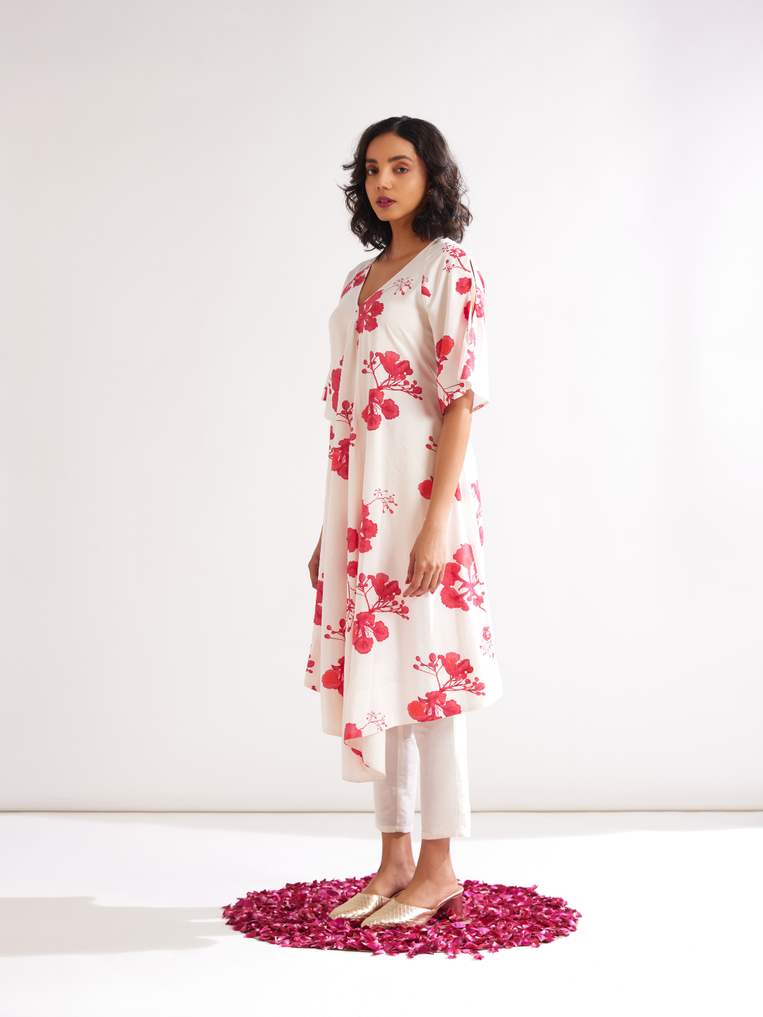 Asymmetrical Gulmohar kurta with cut out sleeves paired with pegged pants- Ivory