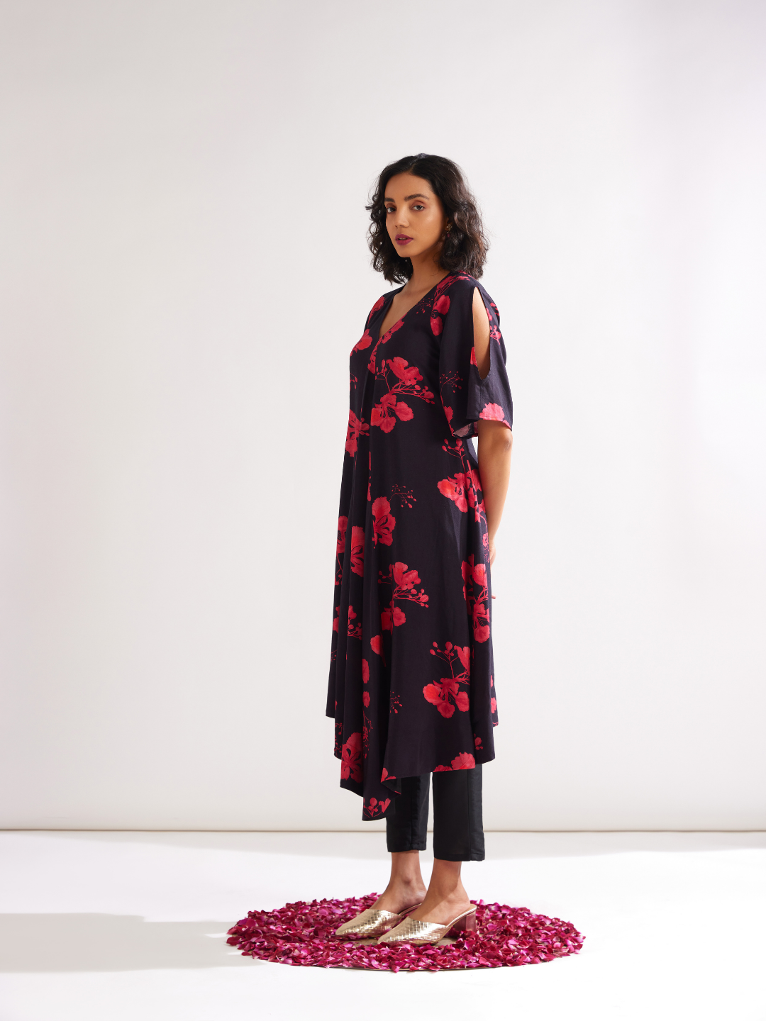 Asymmetrical Gulmohar kurta with cut out sleeves paired with pegged pants- Rich black