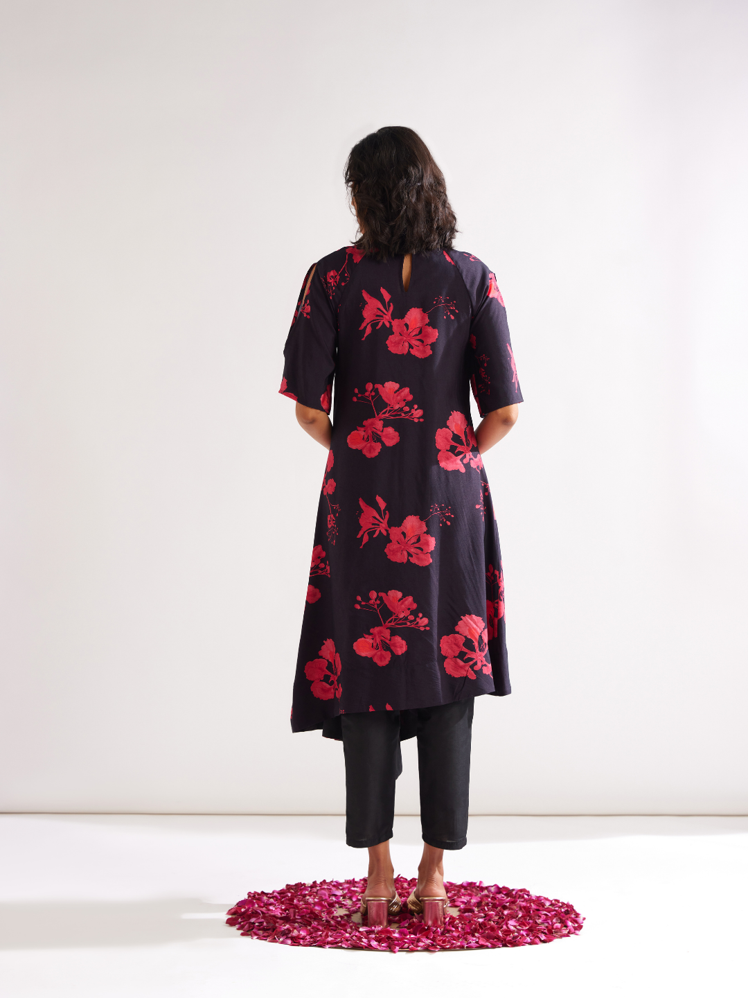 Asymmetrical Gulmohar kurta with cut out sleeves paired with pegged pants- Rich black