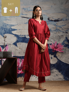 Cotton silk gathered kurta with U-hemline and contrast piping & facing, along with pleated pants Maroon