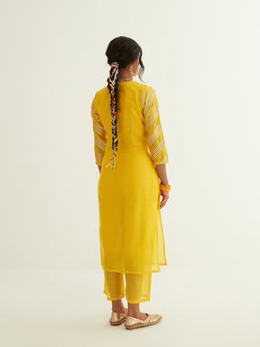 Overlapped neckline chanderi kurta highlighted with Gota Patti with semi-sheer straight pants