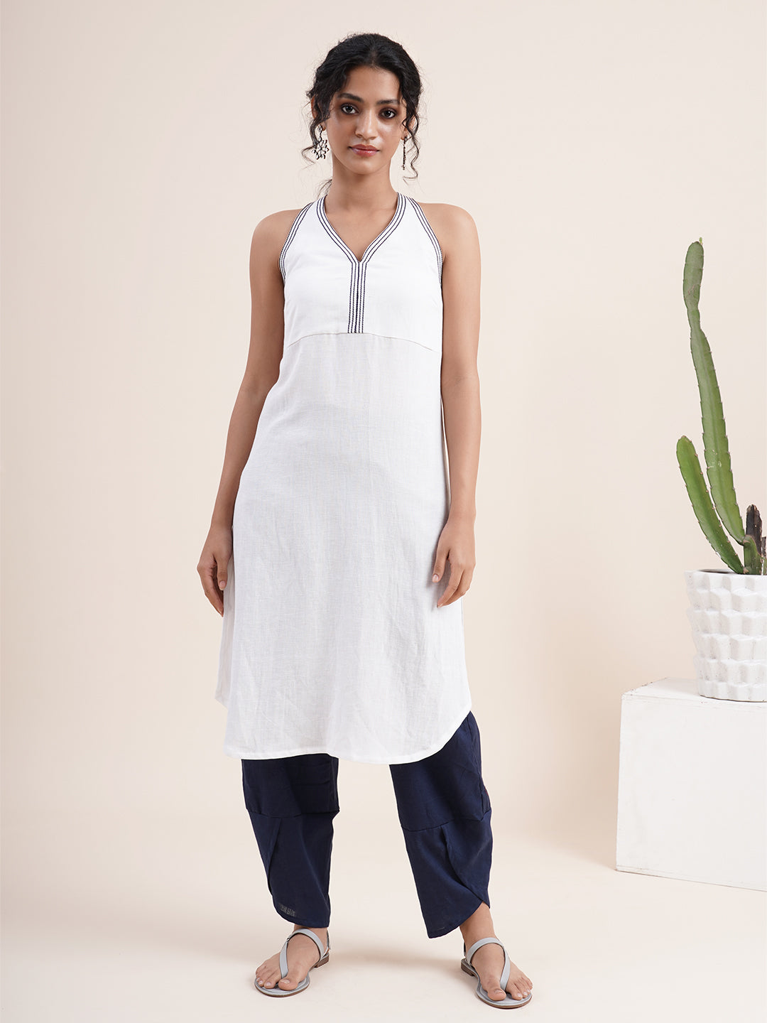 White Sleeveless kurta paired with overlapped hem pants