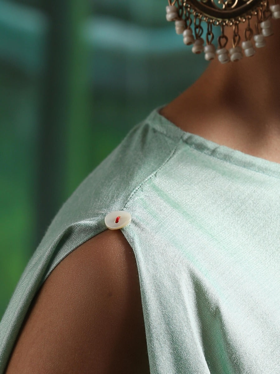 Cotton silk handkerchief hemline top detailed with attached tassels, along with flared dhoti pants Green