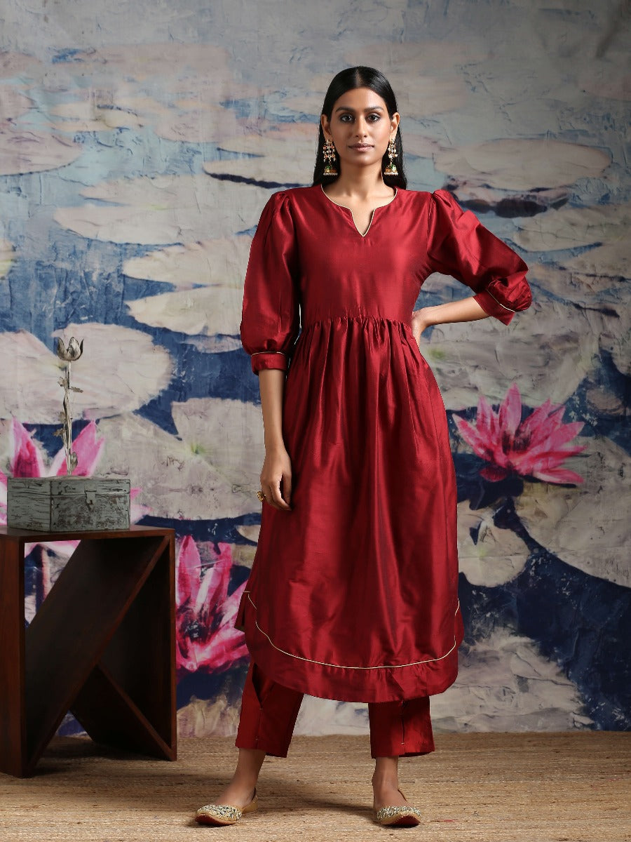 Cotton silk gathered kurta with U-hemline and contrast piping & facing, along with pleated pants Maroon